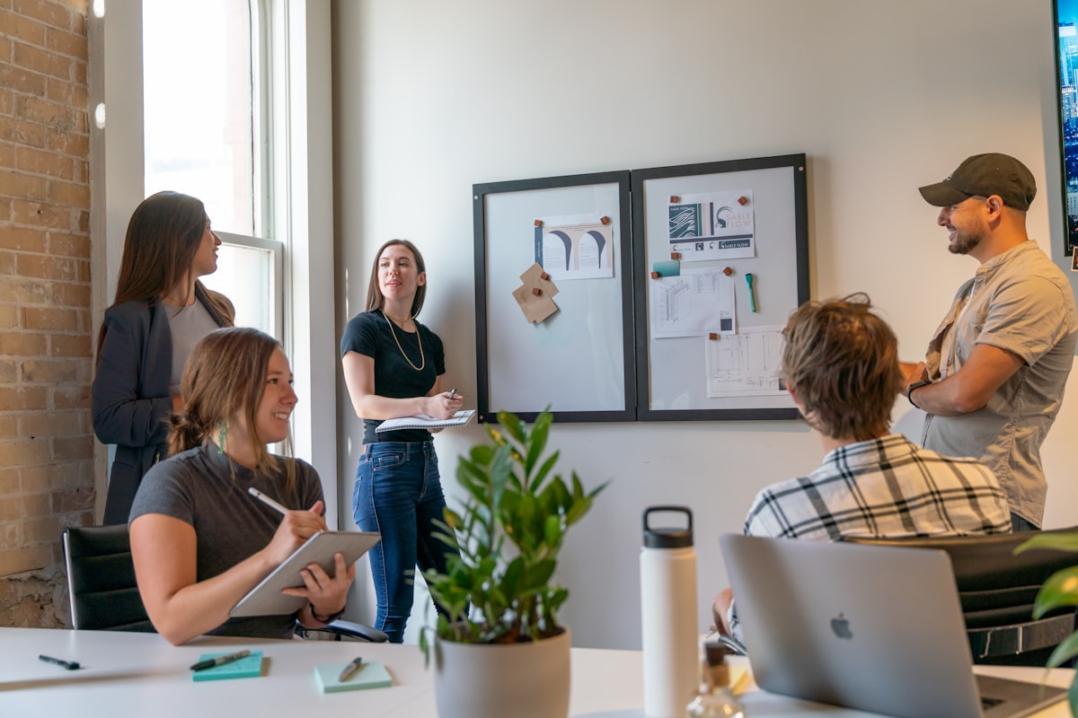 Group of people in a sunlit office during a collaborative workspace meeting