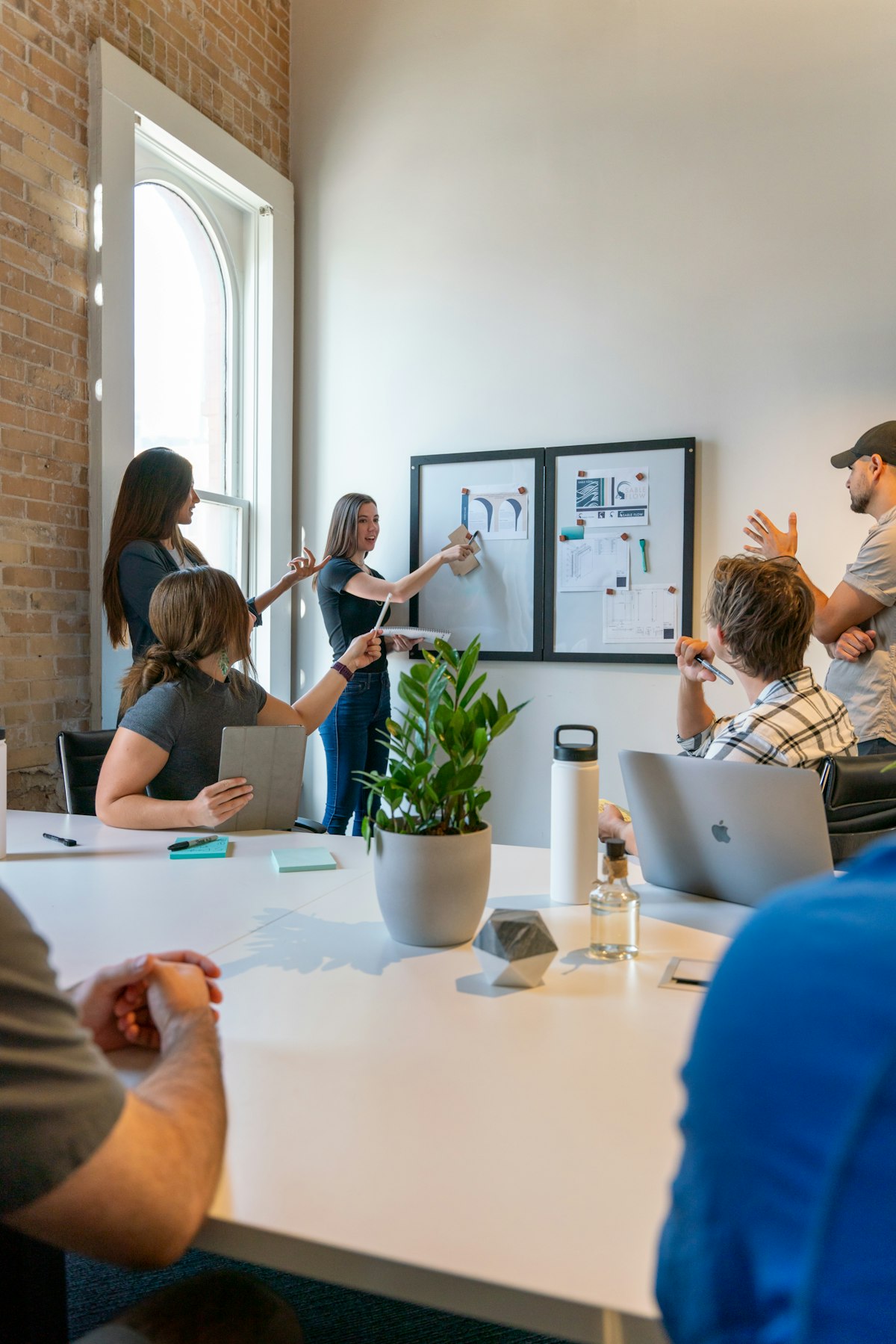 Group of people sitting around a table in an office